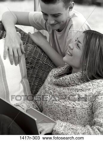 Stock Image - people, couple, computer, laptop, teens, black and white. Fotosearch