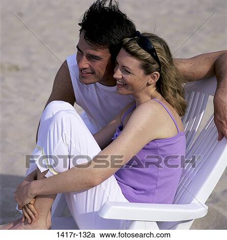 people, couple, sitting, windy, wind, beach, looking View Large Photo Image Stock Image - people, couple, sitting, windy, wind, beach, looking. Fotosearch