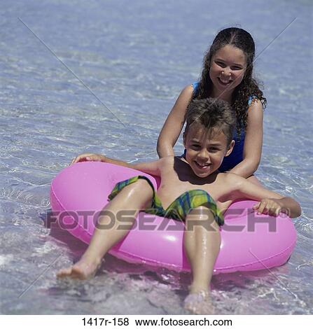 people, floating, water, beach, inner tube, children View Large Photo Image Stock Photo - people, floating, water, beach, inner tube, children. Fotosearch