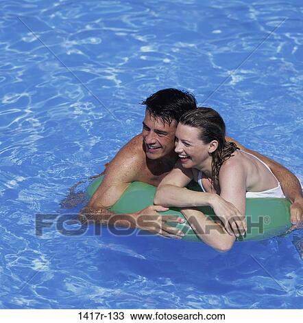 people, floating, water, pool, couple, beach, laughing View Large Photo Image Stock Image - people, floating, water, pool, couple, beach, laughing. Fotosearch