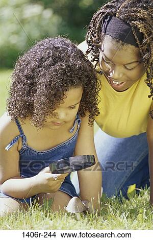 people, glass, magnifying, playing, outdoors, curious, play View Large Photo Image Picture - people, glass, magnifying, playing, outdoors, curious, play. Fotosearch