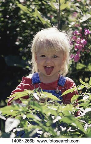 Stock Image - people, hiding, playing, girl, tongue, outdoors, child. Fotosearch