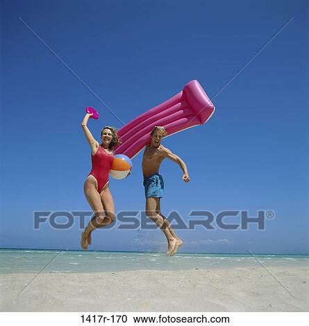 people, jump, jumping, couple, beach, raft View Large Photo Image Stock Image - people, jump, jumping, couple, beach, raft. Fotosearch