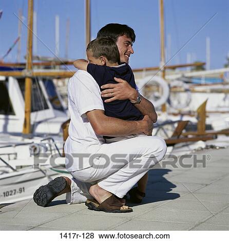 people, outdoors, boats, dock, hugging, family View Large Photo Image Stock Photo - people, outdoors, boats, dock, hugging, family. Fotosearch