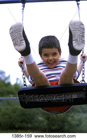 Stock Photo - people, playing, Hispanic, happy, swinging, swing, playground. Fotosearch