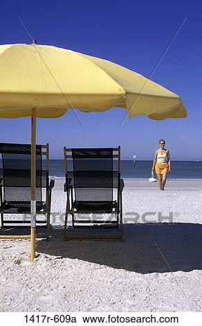 people, relaxation, water, woman, umbrella, walking, ocean View Large Photo Image Stock Image - people, relaxation, water, woman, umbrella, walking, ocean. Fotosearch