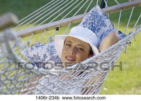 people, relaxation, woman, hat, hammock, swinging, swing View Large Photo Image Stock Image - people, relaxation, woman, hat, hammock, swinging, swing. Fotosearch