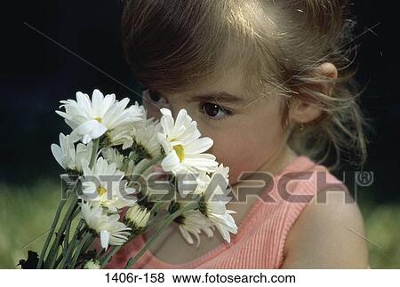 Stock Photo - people, smelling, daisies, girl, flowers, outdoors, child. Fotosearch