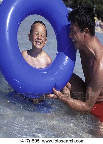 people, smiling, beach, laughing, playful, inner tube View Large Photo Image Stock Photography - people, smiling, beach, laughing, playful, inner tube. Fotosearch