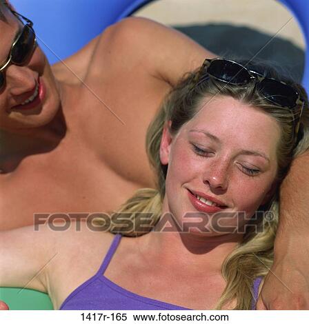 people, smiling, couple, sunglasses, outdoors, relaxing, smile View Large Photo Image Stock Photography - people, smiling, couple, sunglasses, outdoors, relaxing, smile. Fotosearch