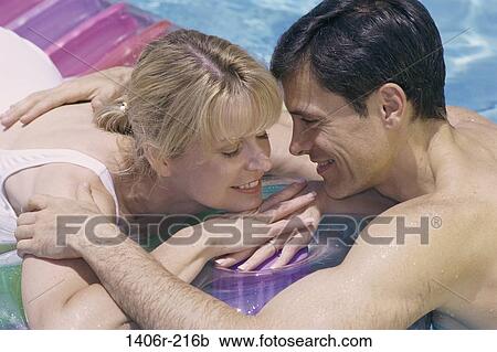 people, swim, floating, water, pool, couple, swimming View Large Photo Image Stock Image - people, swim, floating, water, pool, couple, swimming. Fotosearch