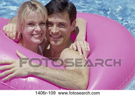 people, swim, pool, couple, swimming, inner tube View Large Photo Image Stock Photo - people, swim, pool, couple, swimming, inner tube. Fotosearch