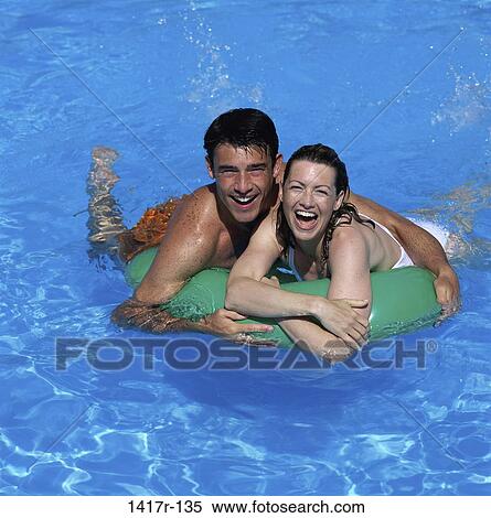 people, swim, pool, couple, swimming, inner tube View Large Photo Image Stock Photography - people, swim, pool, couple, swimming, inner tube. Fotosearch