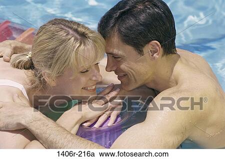 people, swim, relaxation, pool, smiling, couple View Large Photo Image Stock Image - people, swim, relaxation, pool, smiling, couple. Fotosearch