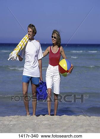people, umbrella, walking, couple, ball, beach, sunglasses View Large Photo Image Stock Image - people, umbrella, walking, couple, ball, beach, sunglasses. Fotosearch