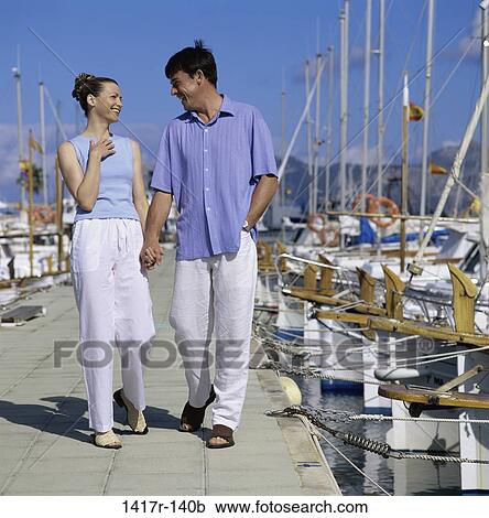 Stock Image - people, walking, couple, outdoors, dock. Fotosearch