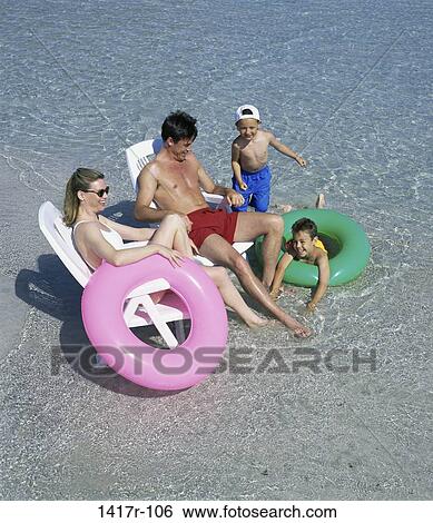 people, water, beach, chairs, family View Large Photo Image Stock Photograph - people, water, beach, chairs, family. Fotosearch