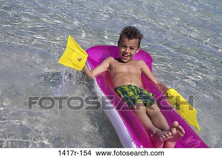 people, water, beach, raft, boy, child View Large Photo Image Picture - people, water, beach, raft, boy, child. Fotosearch