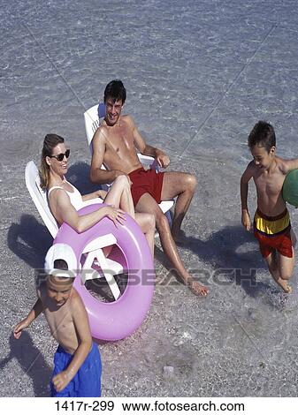 people, water, beach, sunglasses, inner tube, relaxing View Large Photo Image Stock Photo - people, water, beach, sunglasses, inner tube, relaxing. Fotosearch