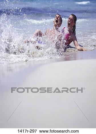 Stock Photo - people, water, couple, beach, splash, splashing, surprise. Fotosearch