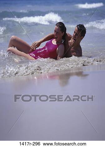 people, water, couple, ocean, beach, shore, wet View Large Photo Image Stock Photograph - people, water, couple, ocean, beach, shore, wet. Fotosearch