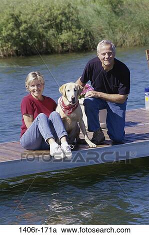 Stock Image - people, water, dog, couple, senior, pet, outdoors. Fotosearch