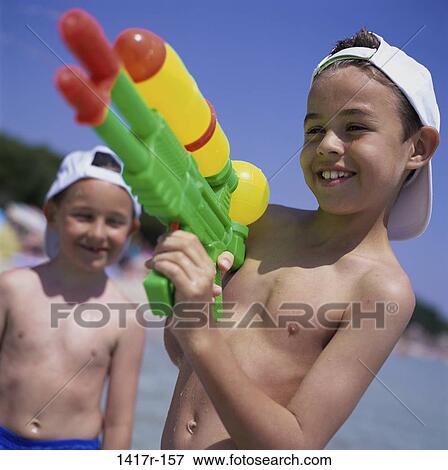 people, water, hat, gun, beach, children, boys View Large Photo Image Stock Photo - people, water, hat, gun, beach, children, boys. Fotosearch