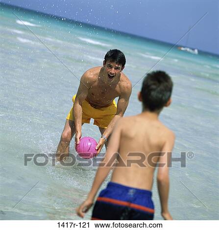 people, water, playing, ball, beach, family View Large Photo Image Stock Image - people, water, playing, ball, beach, family. Fotosearch