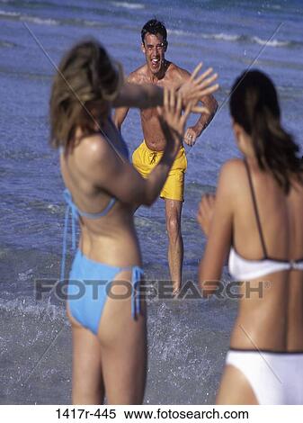 people, water, playing, beach, playful, friends, play View Large Photo Image Stock Photography - people, water, playing, beach, playful, friends, play. Fotosearch