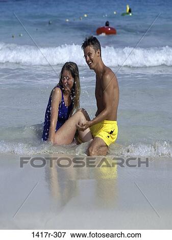 people, water, playing, couple, beach, laughing, splash View Large Photo Image Stock Photo - people, water, playing, couple, beach, laughing, splash. Fotosearch