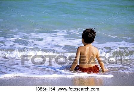 Picture - people, water, playing, ocean, sitting, Hispanic. Fotosearch