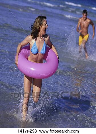 Stock Photo - people, water, running, couple, ocean, beach. Fotosearch