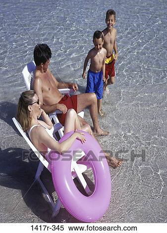 people, water, sitting, beach, inner tube, relaxing, chairs View Large Photo Image Stock Photography - people, water, sitting, beach, inner tube, relaxing, chairs. Fotosearch