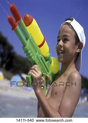 people, water, smiling, playing, gun, beach, playful View Large Photo Image Stock Image - people, water, smiling, playing, gun, beach, playful. Fotosearch