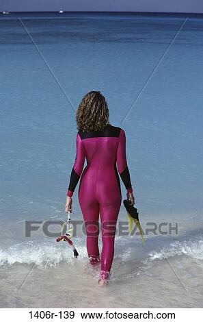 Stock Photo - people, water, woman, walking, beach, sports, water sports. Fotosearch