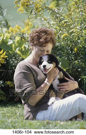 people, woman, dog, puppy, pet, outdoors, Middle-aged View Large Photo Image Picture - people, woman, dog, puppy, pet, outdoors, Middle-aged. Fotosearch