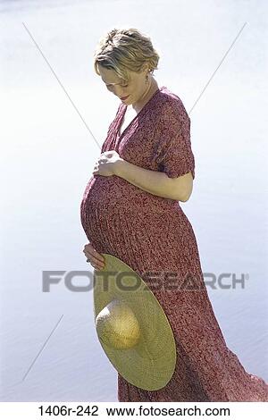 people, woman, hat, daydreaming, stomach, holding, standing View Large Photo Image Stock Image - people, woman, hat, daydreaming, stomach, holding, standing. Fotosearch
