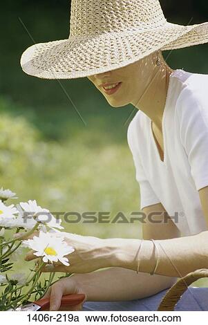 relaxation, woman, hat, flowers, gardening, outdoors, relaxing View Large Photo Image Stock Image - relaxation, woman, hat, flowers, gardening, outdoors, relaxing. Fotosearch