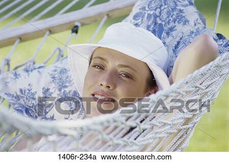 relaxed, people, woman, smiling, hat, hammock View Large Photo Image Stock Image - relaxed, people, woman, smiling, hat, hammock. Fotosearch