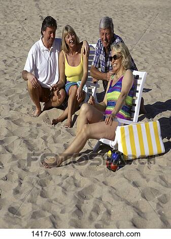 sand, people, relaxation, smiling, beach, laughing, outdoors View Large Photo Image Stock Image - sand, people, relaxation, smiling, beach, laughing, outdoors. Fotosearch