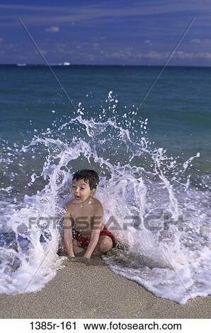 sand, people, water, playing, male, ocean, beach View Large Photo Image Stock Image - sand, people, water, playing, male, ocean, beach. Fotosearch