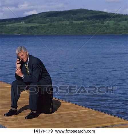 Stock Photo - telephone, briefcase, sitting, senior, phone. Fotosearch