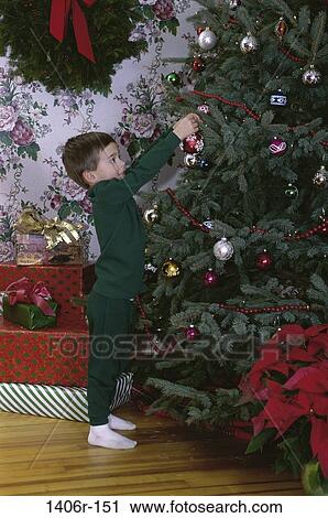 tree, hanging, Christmas, boy, Christmas tree, gifts, presents View Large Photo Image Stock Image - tree, hanging, Christmas, boy, Christmas tree, gifts, presents. Fotosearch