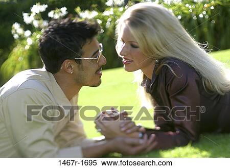 grass, multiethnic, people, hands, smiling, couple View Large Photo Image Stock Photography - grass, multiethnic, people, hands, smiling, couple. Fotosearch