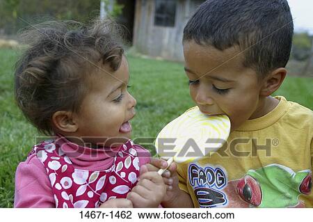 Stock Image - multiethnic, people, eating, Hispanic, candy, children. Fotosearch