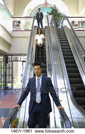 multiethnic, people, escalator, standing, business, serious View Large Photo Image Stock Image - multiethnic, people, escalator, standing, business, serious. Fotosearch