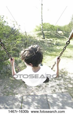 Stock Image - overhead, people, playing, swinging, swing, back, boy. Fotosearch