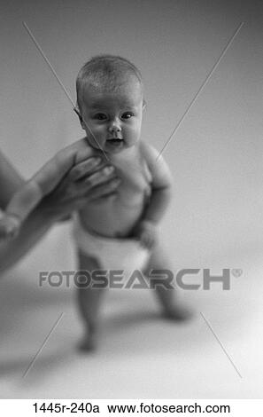 people, baby, holding, standing, stand, black and white View Large Photo Image Stock Image - people, baby, holding, standing, stand, black and white. Fotosearch