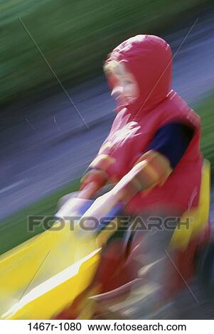 Stock Image - people, blur, playing, riding, boy, motion, outdoors. Fotosearch