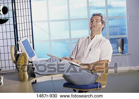 Stock Image - people, desk, home, computer, typing. Fotosearch